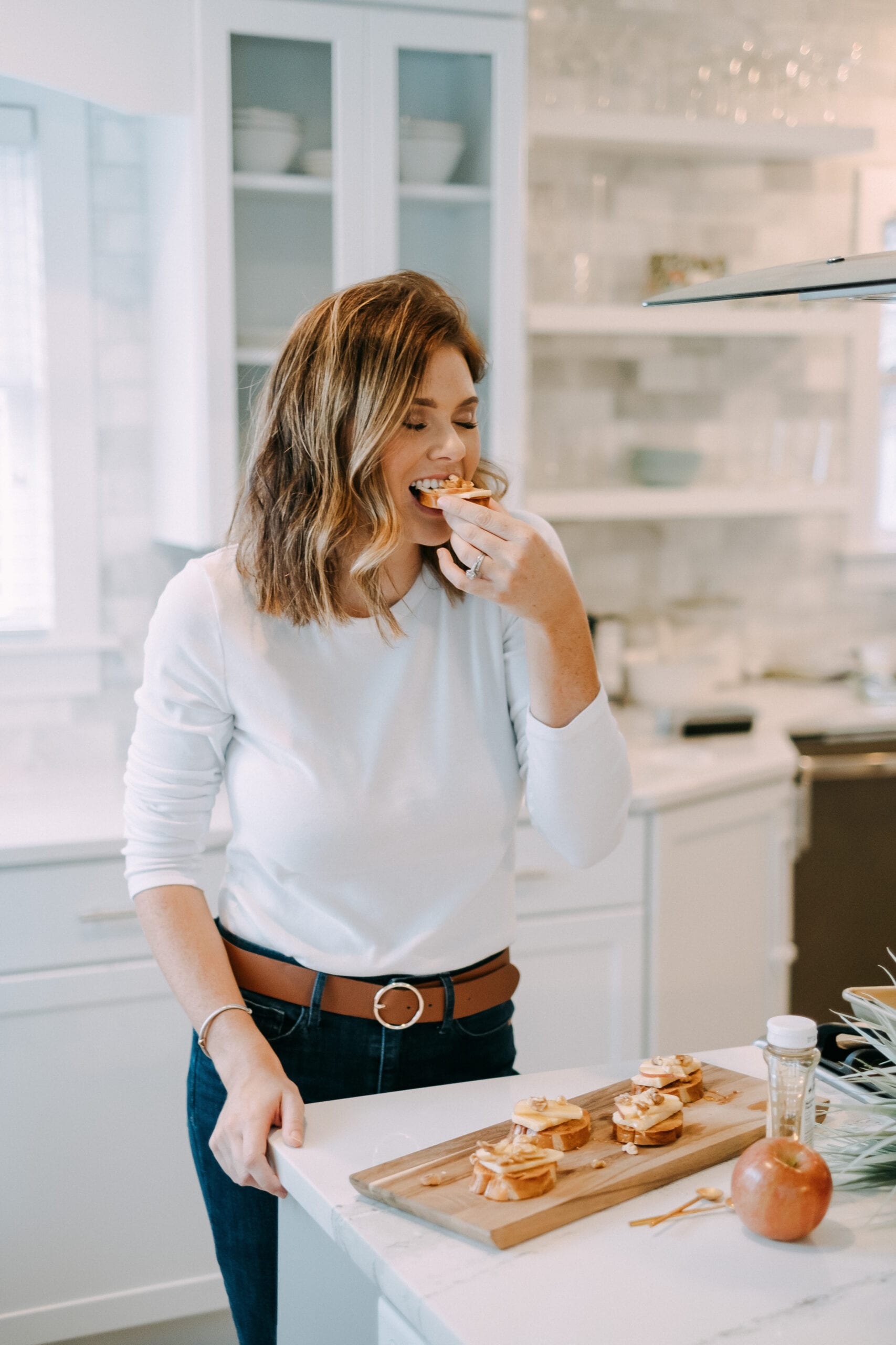 girl taking a bite of toast