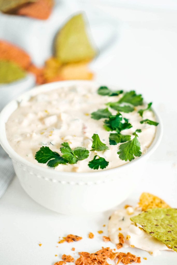 Mexican corn dip in a bowl surrounded by chips