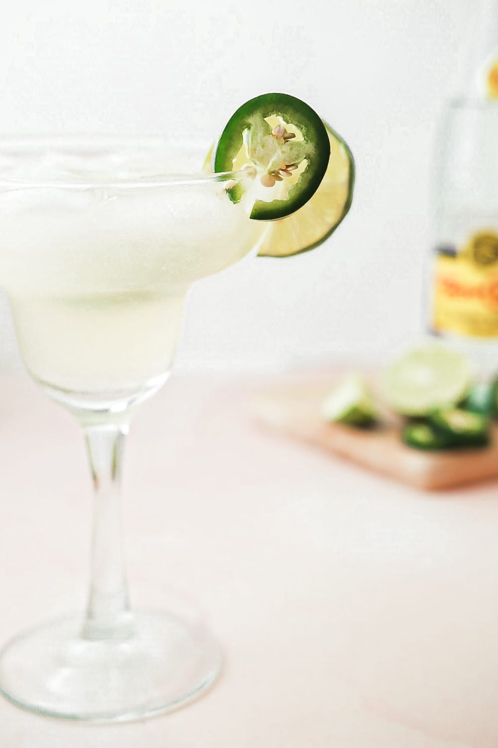 Spicy margarita garnished with jalapeno and lime.
