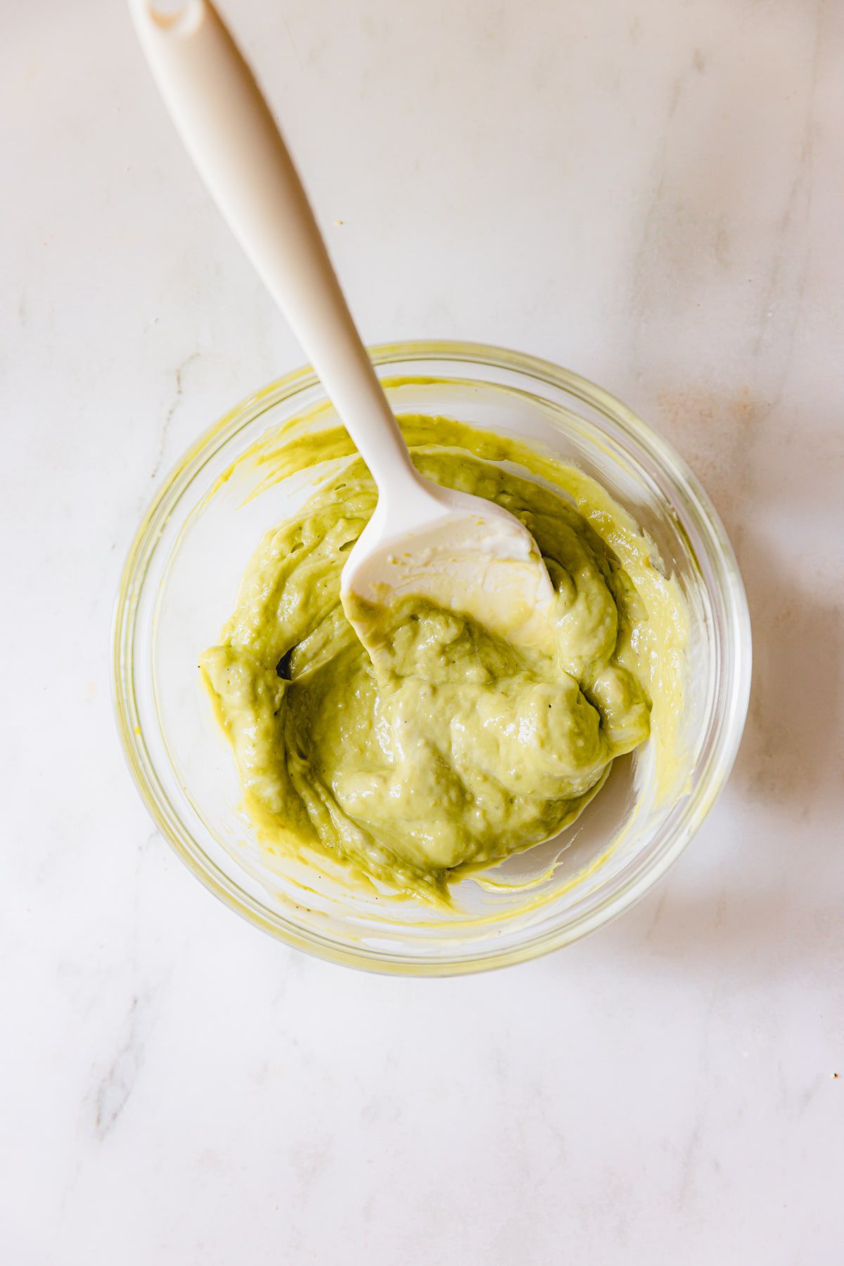 Small mixing bowl with homemade avocado ranch sauce. 