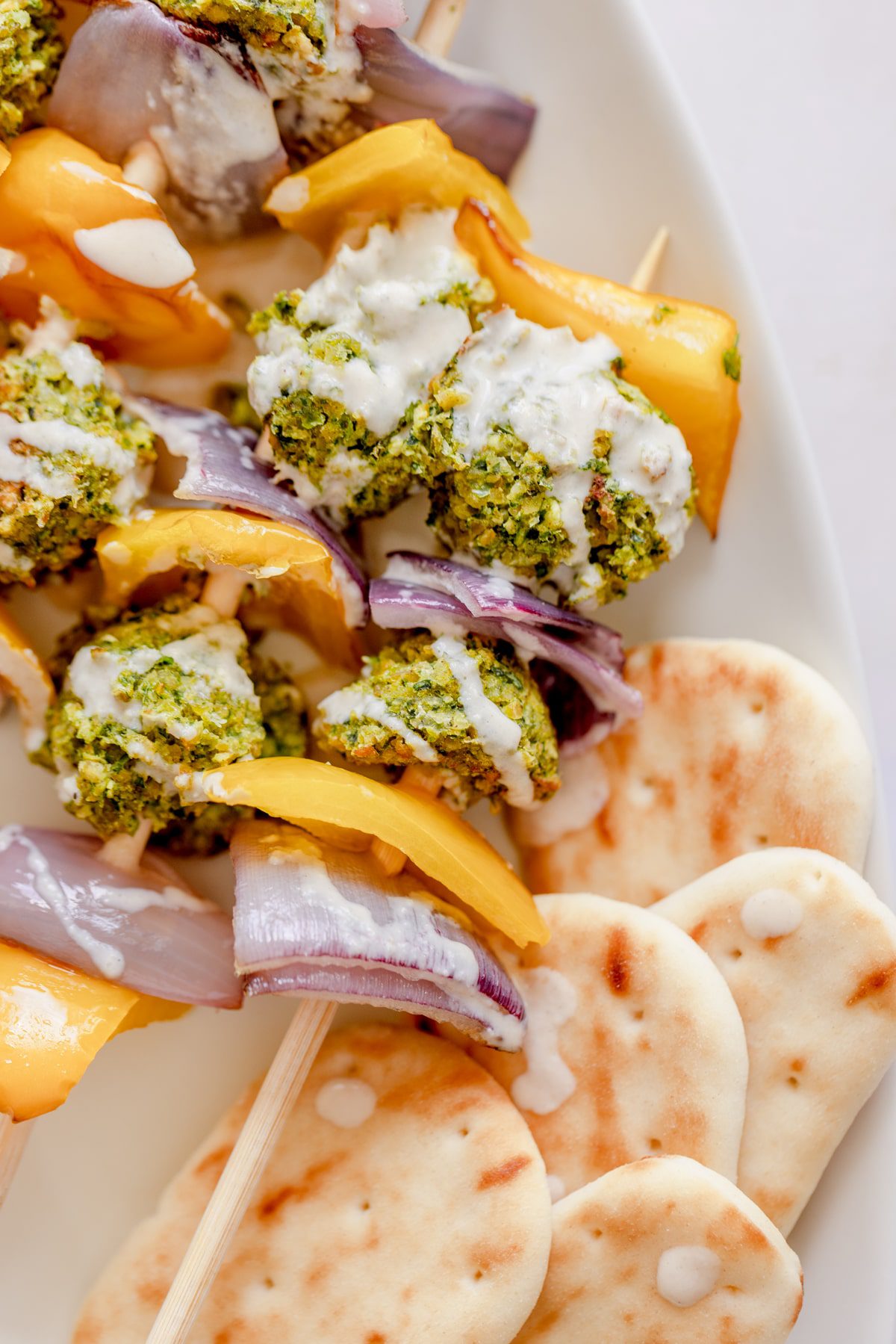 Falafel kebabs drizzled with a lemon tahini sauce. 