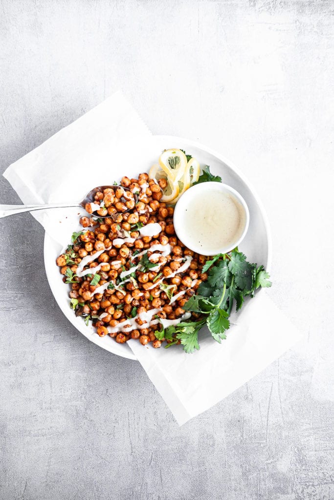 bowl of chili onion crunch chickpeas with tahini