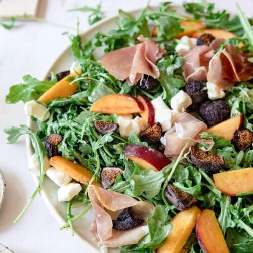 large plate of peach prosciutto salad