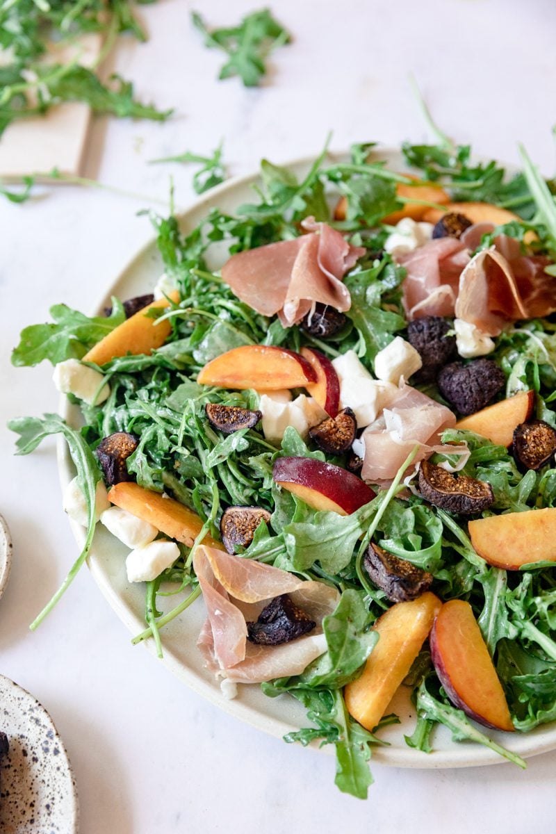 large plate of peach prosciutto salad