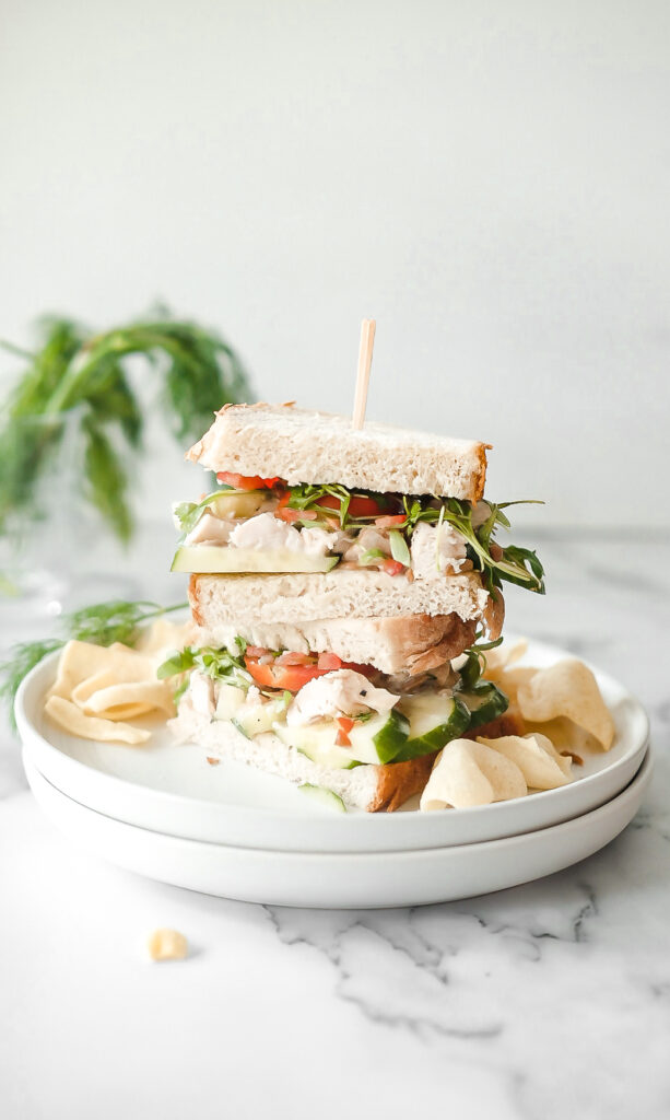 chicken salad sandwich cut in half and stacked. 