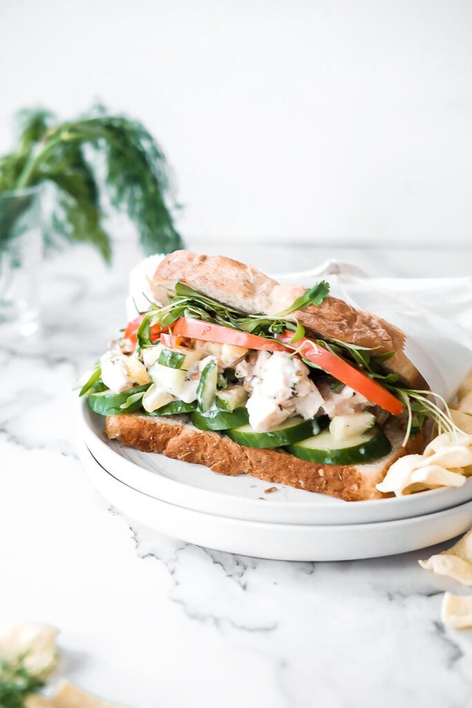 cucumber chicken salad on a sandwich wrapped in parchment