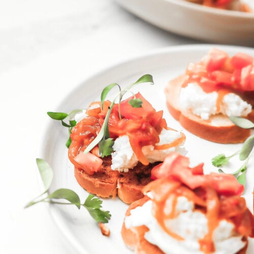 tomato and onion bruschetta with micro green garnish