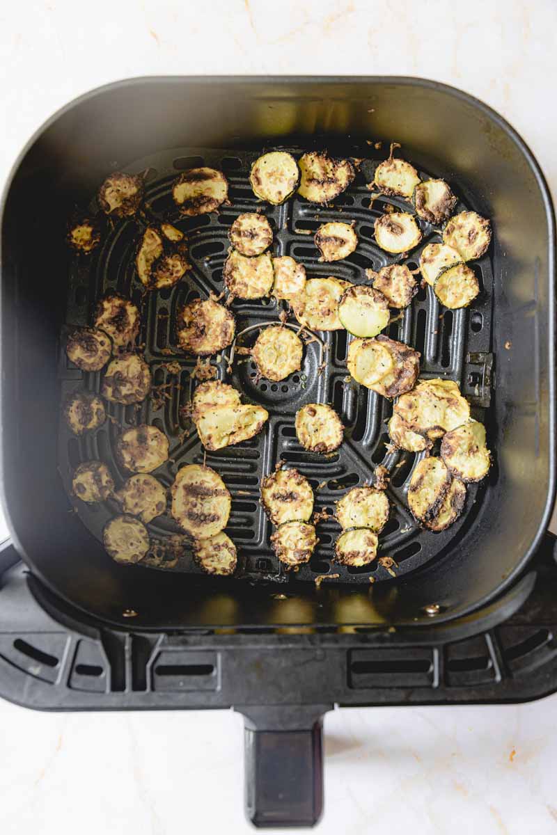 Air fried squash in air fryer basket. 