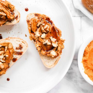 white plate with 3 pieces of toast with pumpkin spread