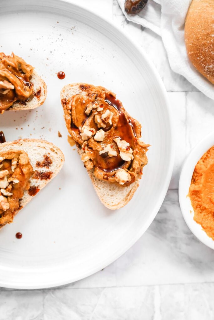 white plate with 3 pieces of toast with pumpkin spread