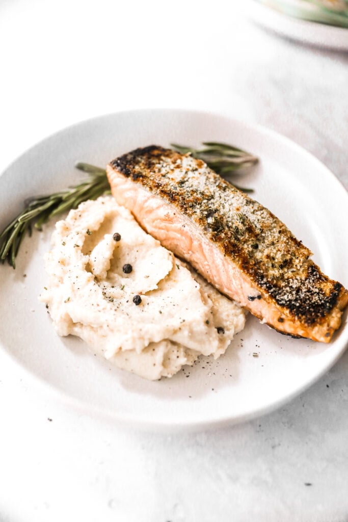 plated crispy skin salmon over mashed potatoes 