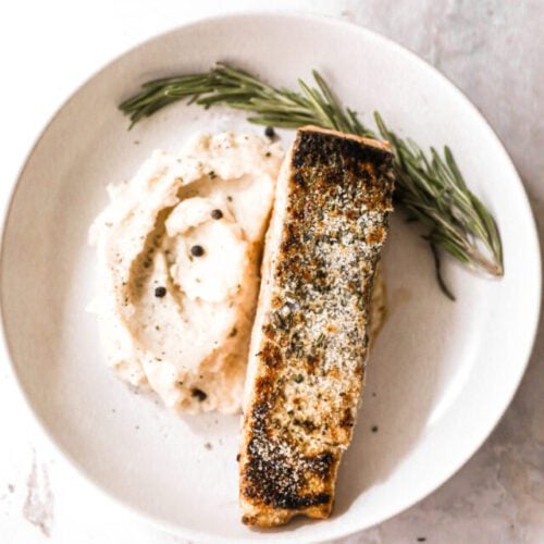 crispy salmon plated with rosemary and mashed potatoes