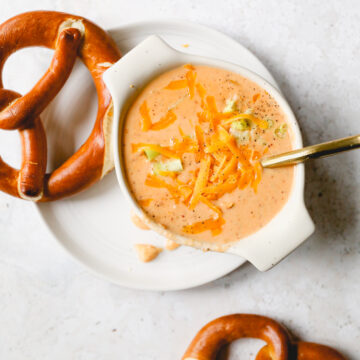 beer cheese potato soup surrounded by soft pretzels