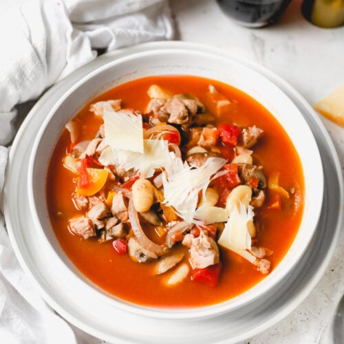 bowl of chicken cacciatore soup topped with parmesan