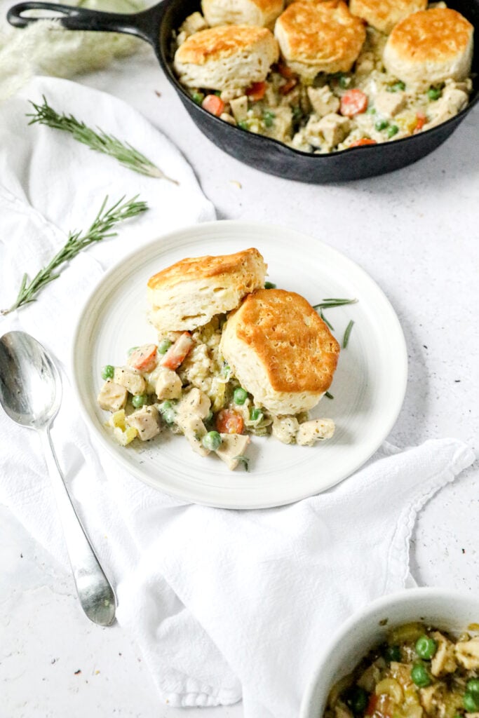 Biscuit pot pie on a white plate with white linen