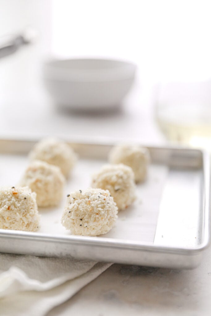 mini cheese balls covered in Panko on a baking sheet 