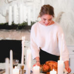 Sara setting down turkey on thanksgiving table