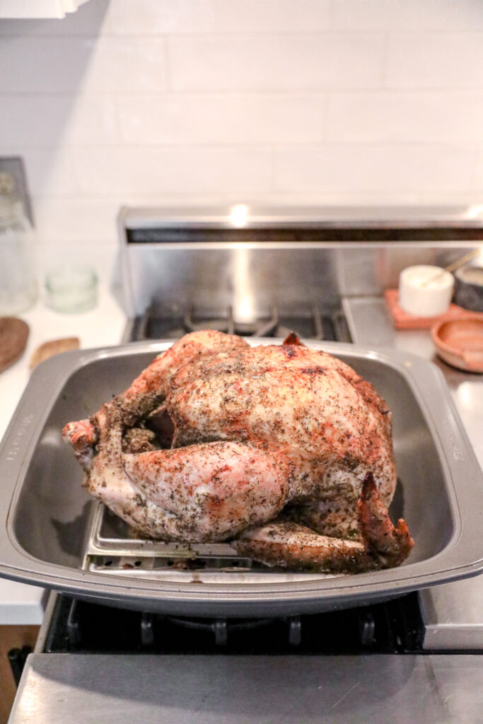 barely cooked turkey on roasting pan