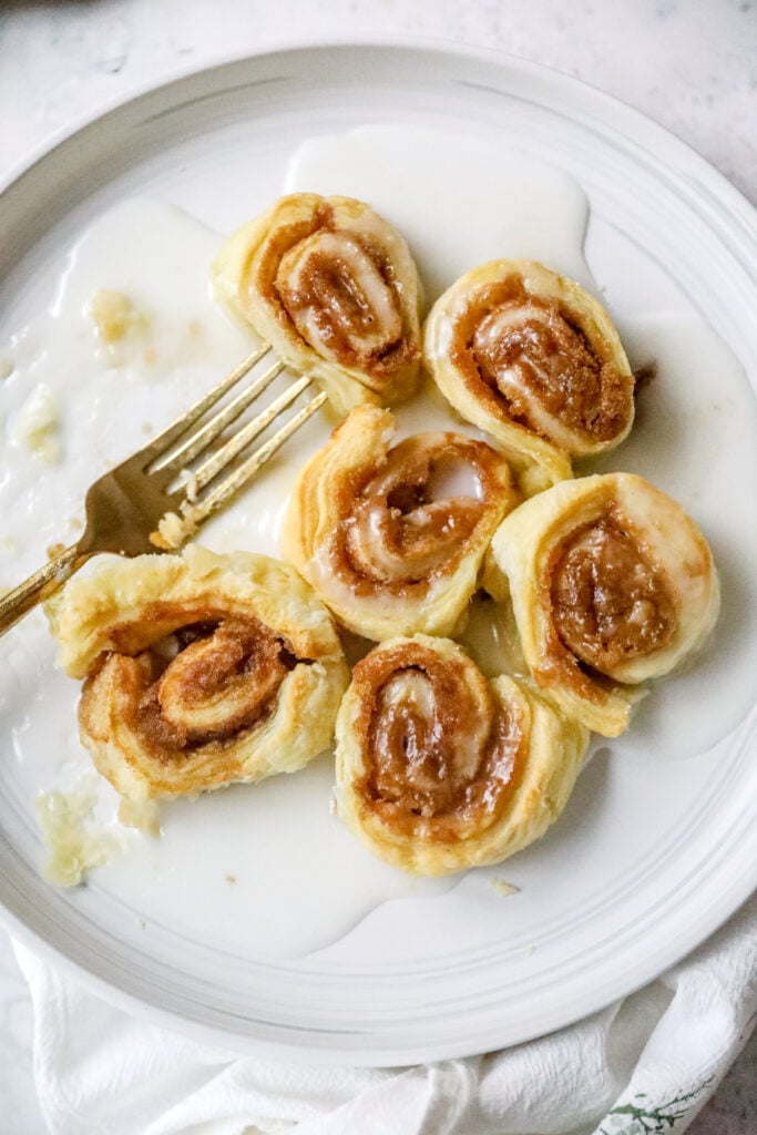 plate of air fried cinnamon rolls with a gold fork and linen
