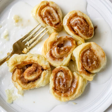 air fried cinnamon rolls on white plate with gold fork