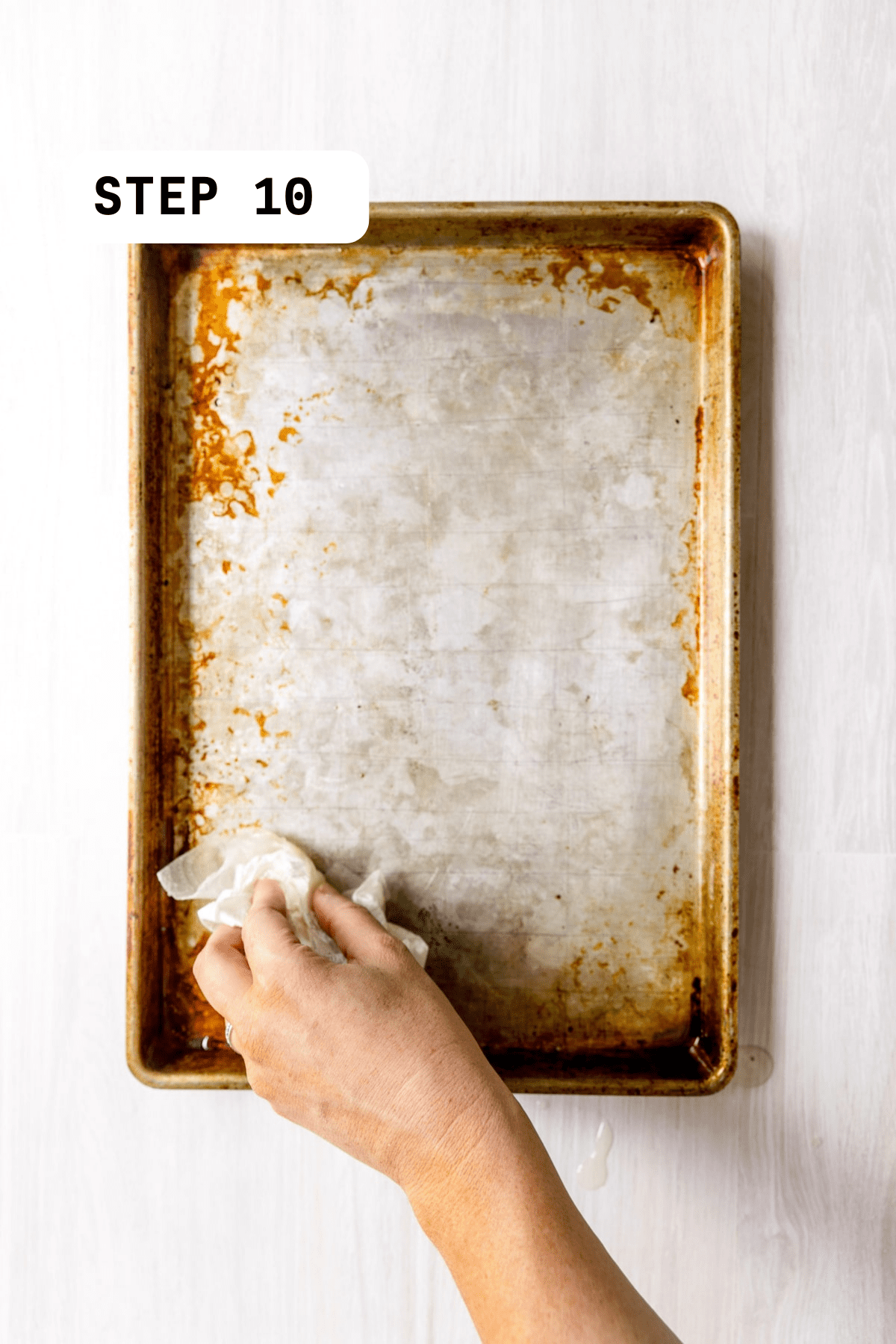 Greasing a sheet pan with canola oil.