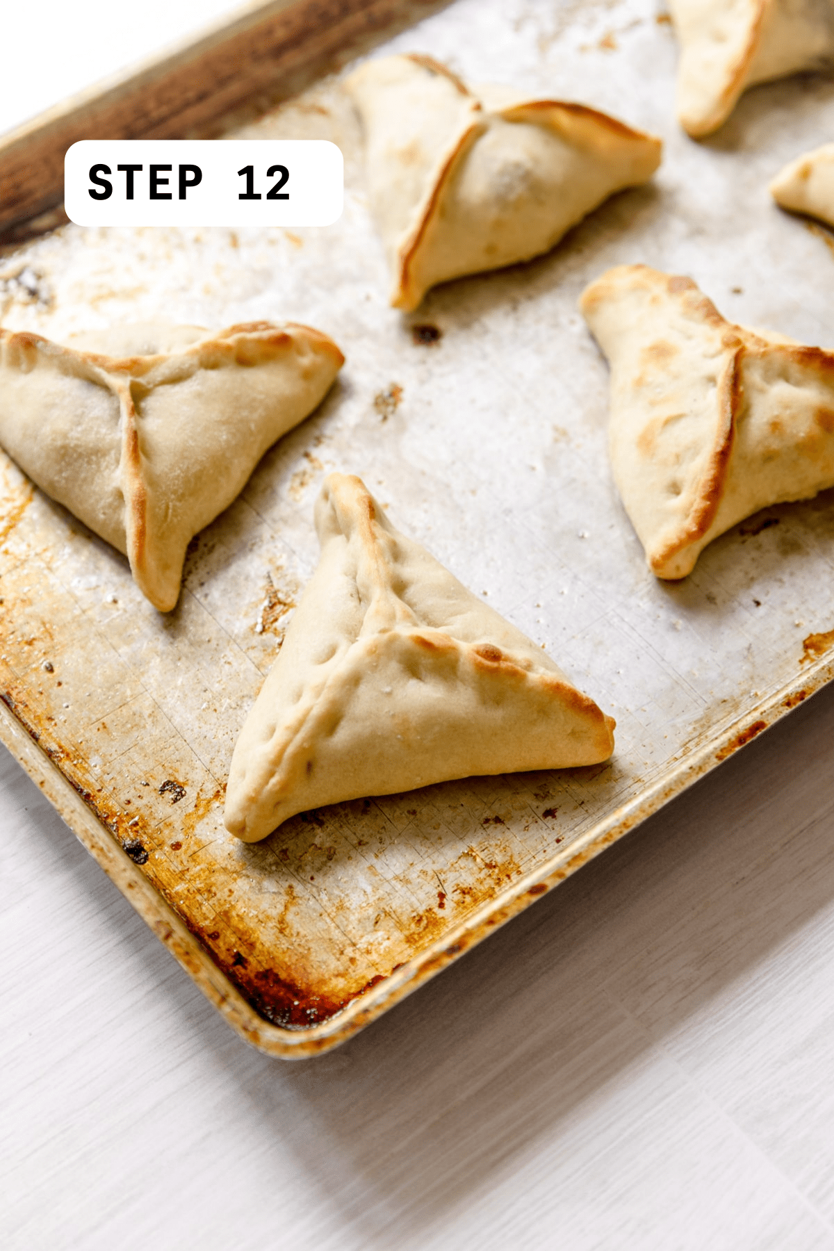 Cooked spinach fatayer on a baking sheet.