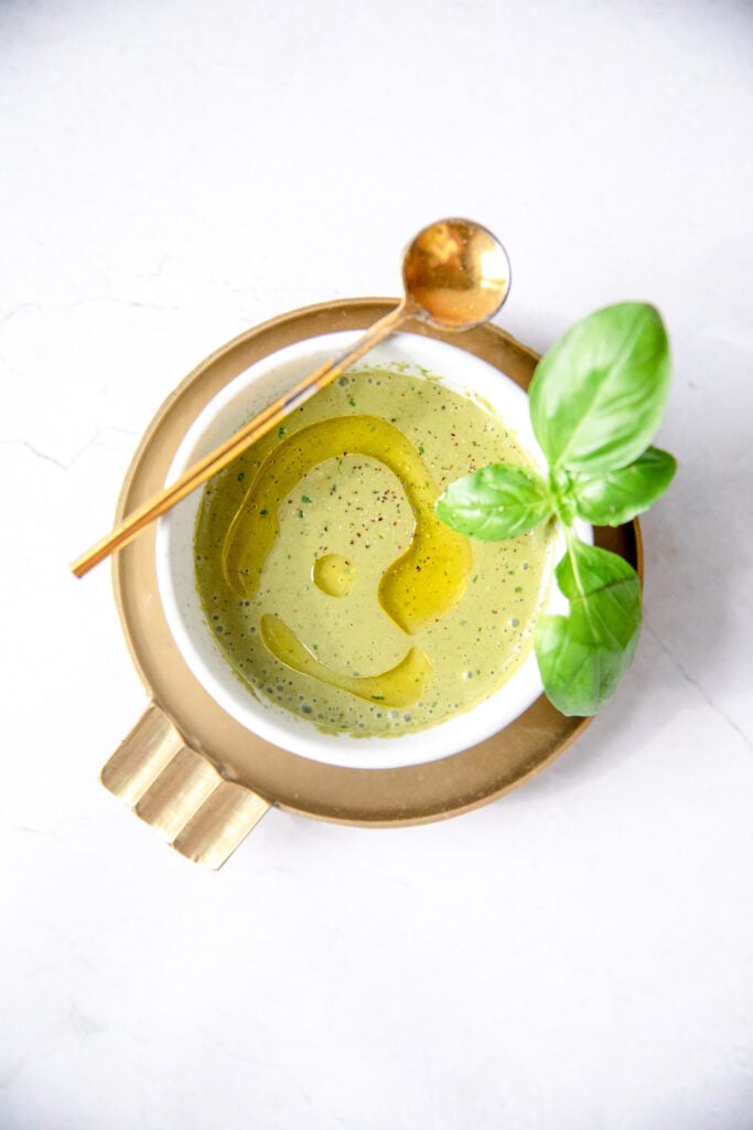 basil balsamic vinaigrette in a white bowl with gold tasting spoon