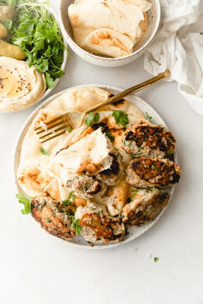 plate of Chicken Kafta with pita and a gold fork