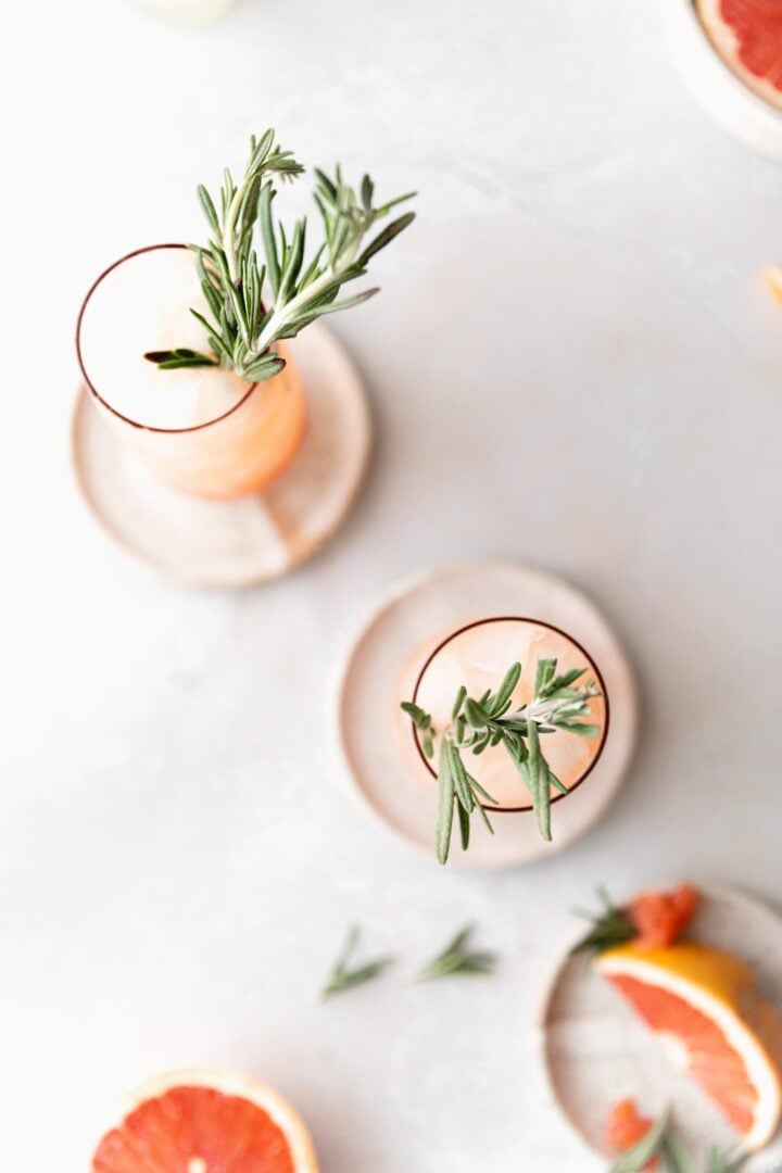 top down shot of 2 pink mules, focused on the rosemary garnish 