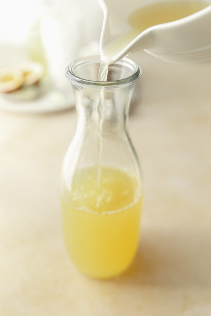 pouring the green tea into a pitcher