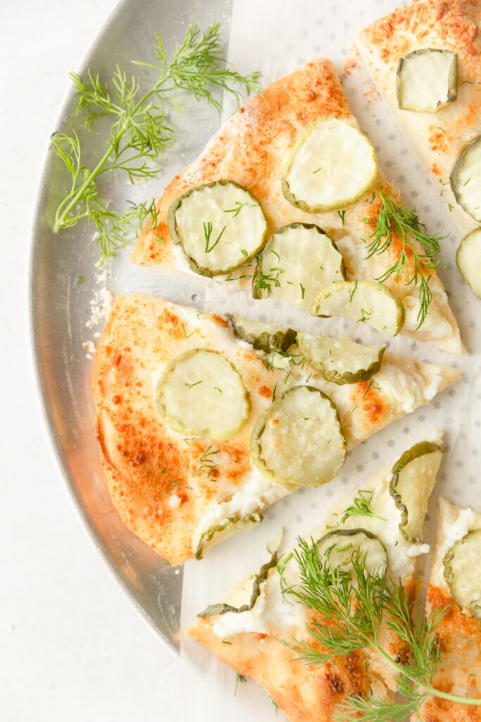 3 slices of dill pickle pizza with fresh dill 