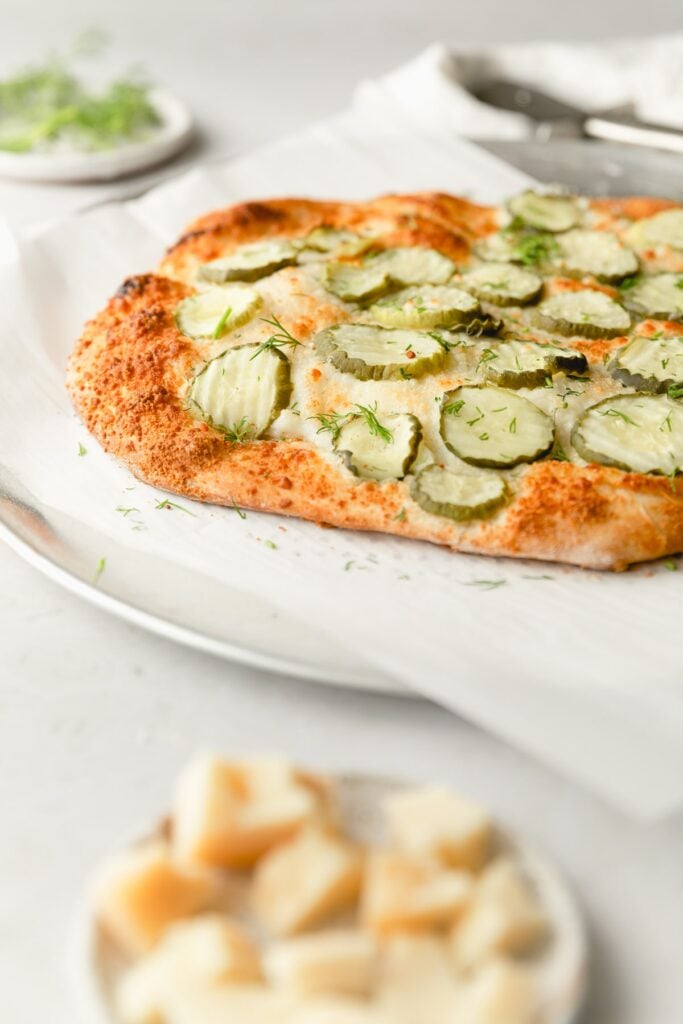 straight on shot of pizza on a metal pan with parchment 