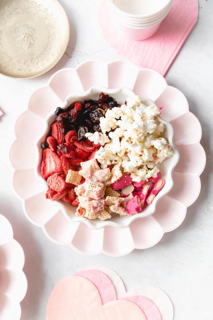 plate of ingredients to make sweet pink Chex mix 