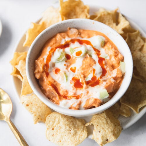 bowl of buffalo jackfruit dip surrounded by tortilla chips