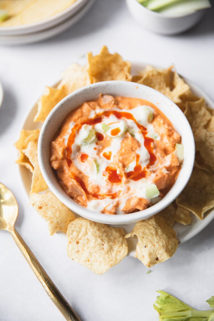 bowl of buffalo jackfruit dip surrounded by tortilla chips