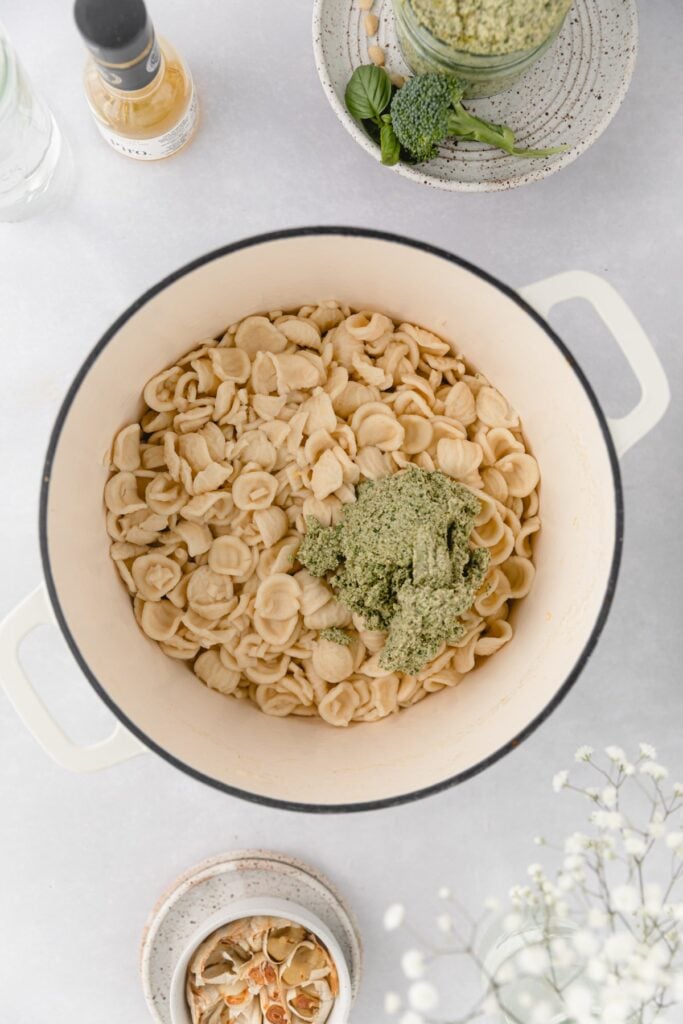 pasta in a dutch oven with broccoli pesto dumped on top