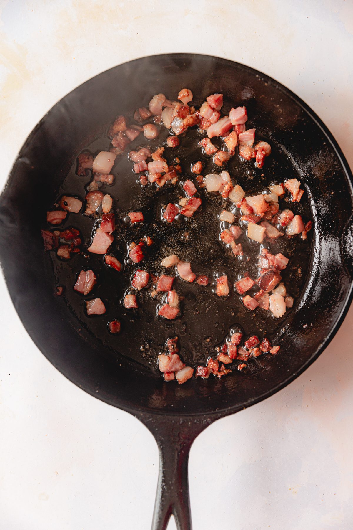 Crispy pancetta in a cast iron skillet. 