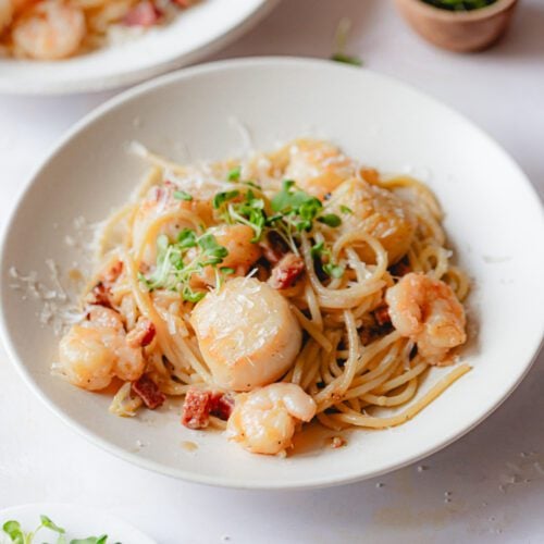 Shrimp scallop pasta in a white bowl.