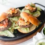 close up of nacho black bean burger with bun on top