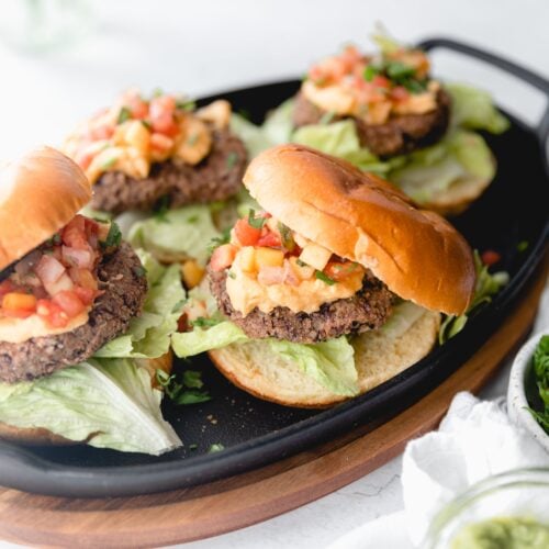 close up of nacho black bean burger with bun on top