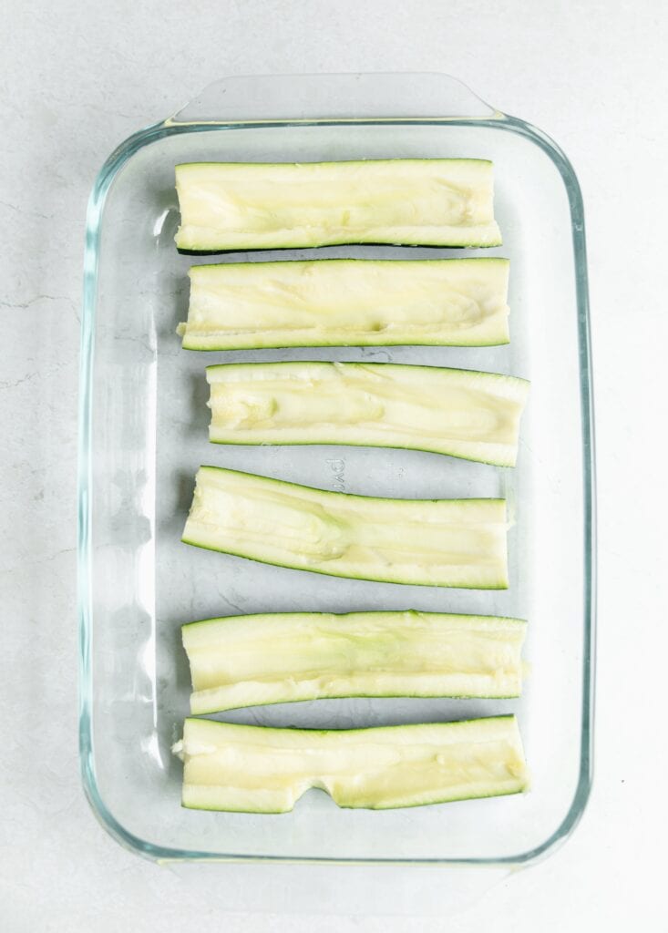 cored zucchini in a baking dish