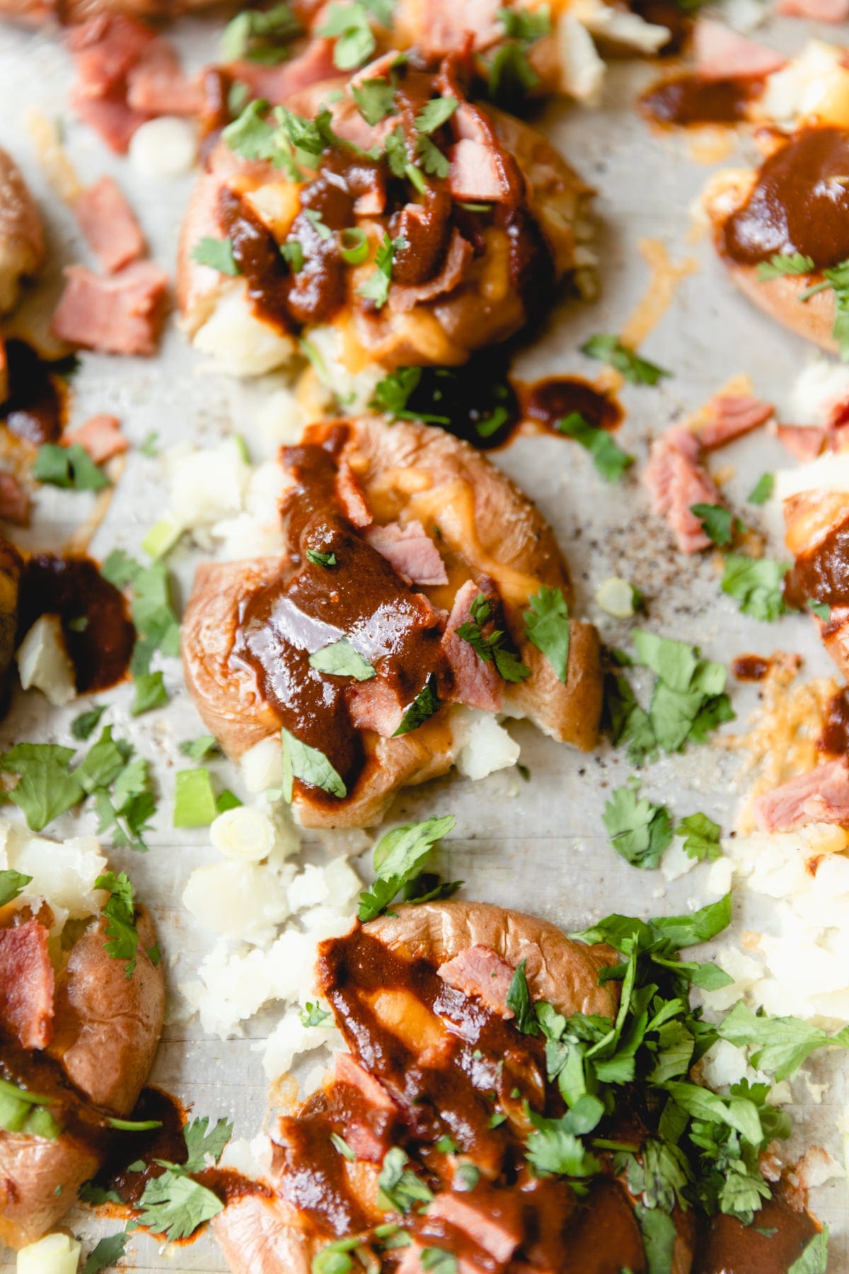 sheet tray with smashed potatoes and toppings