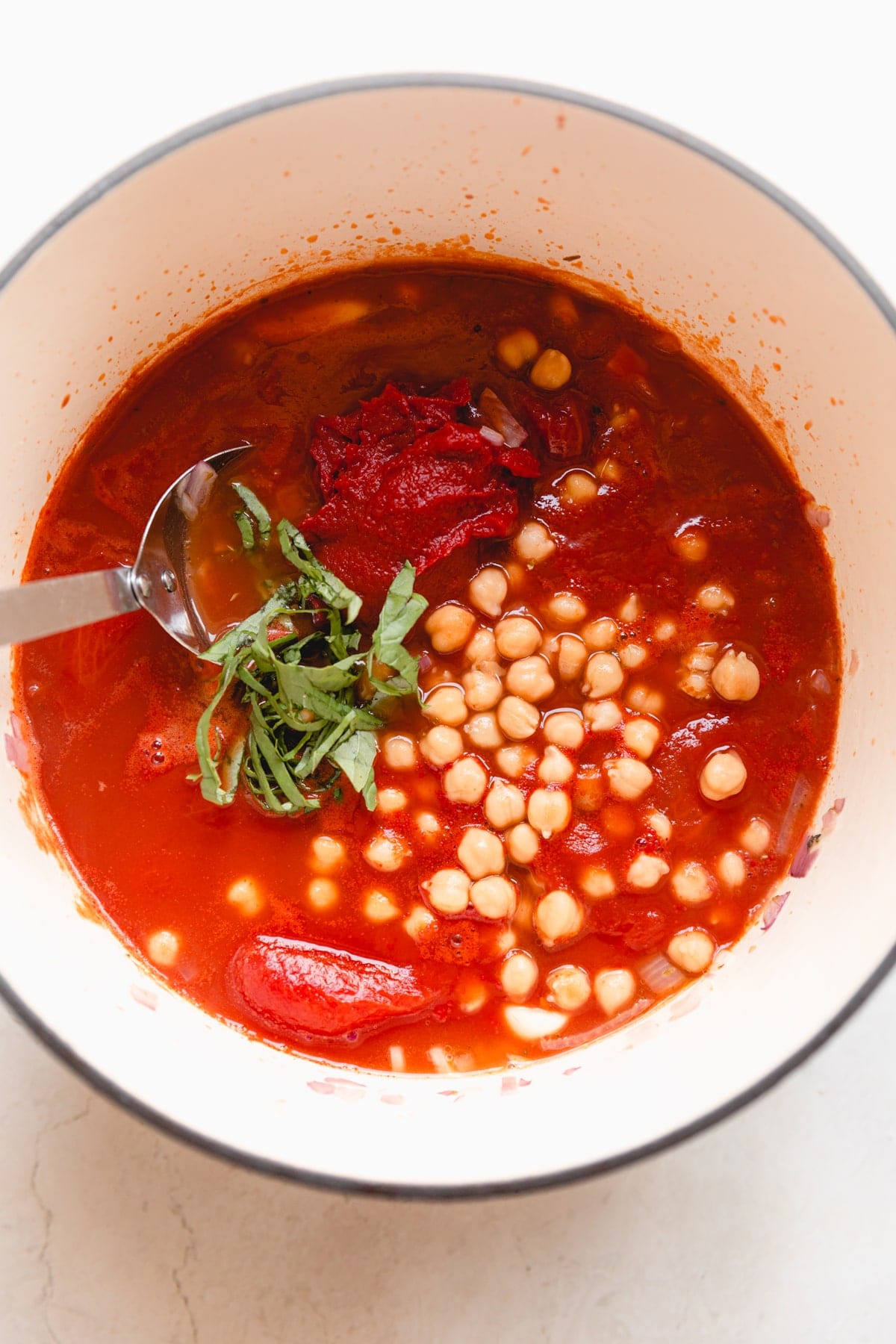 white pot with caprese soup ingredients
