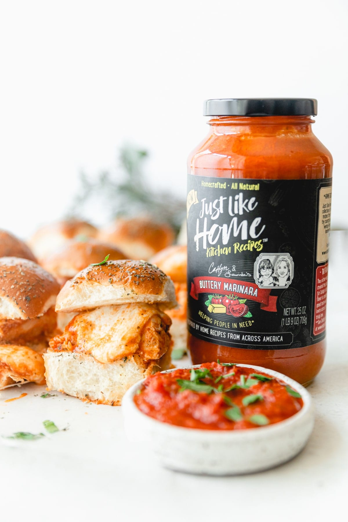 jar of Just Like Home Buttery Marinara next to a Chicken Parmesan Slider