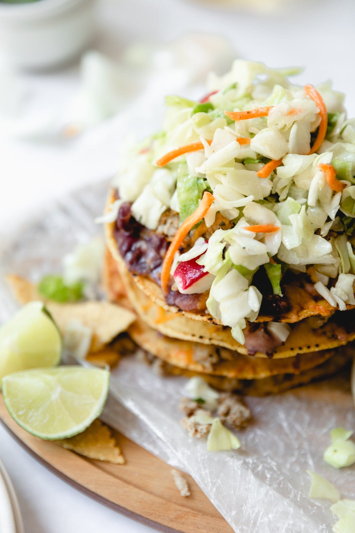 layered taco salad tostada with sliced limes
