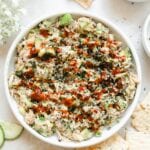 spicy low carb crab dip in a white bowl drizzled with sriacha