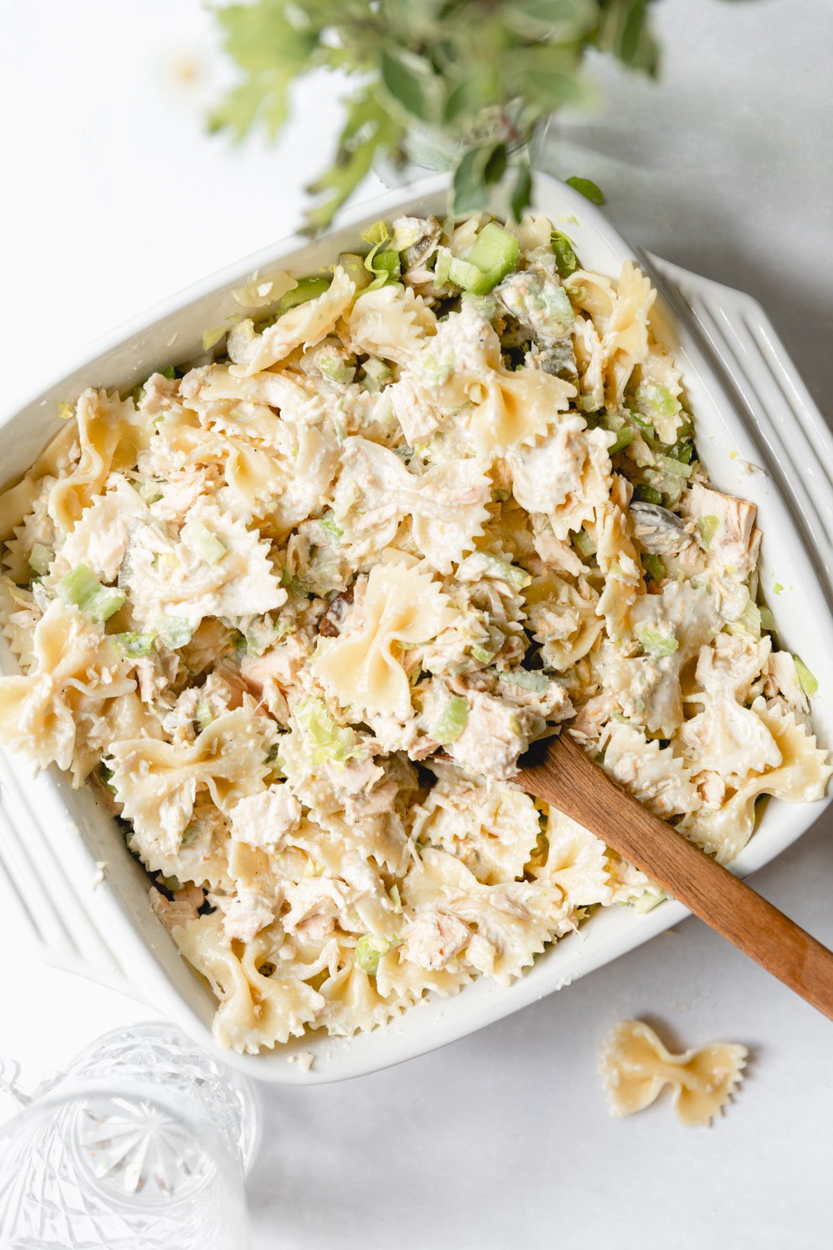 tuna pasta salad in a white square dish with a spoon in it