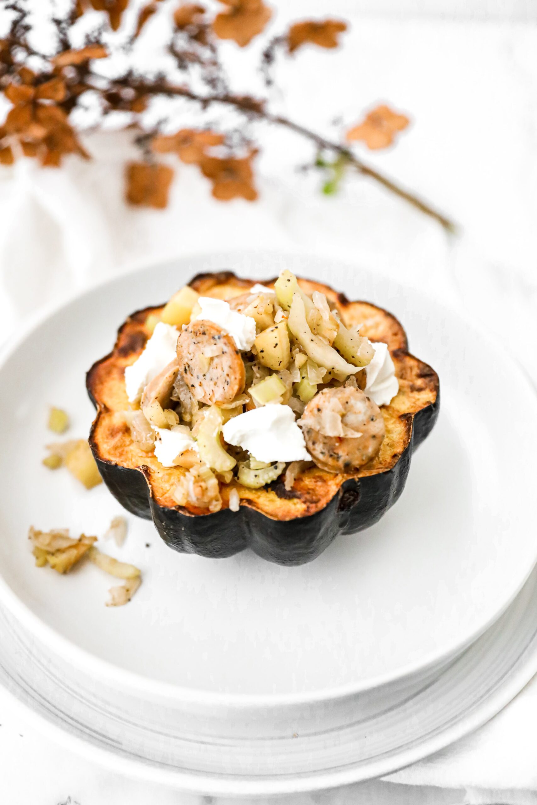 stuffed acorn squash on a white plate 
