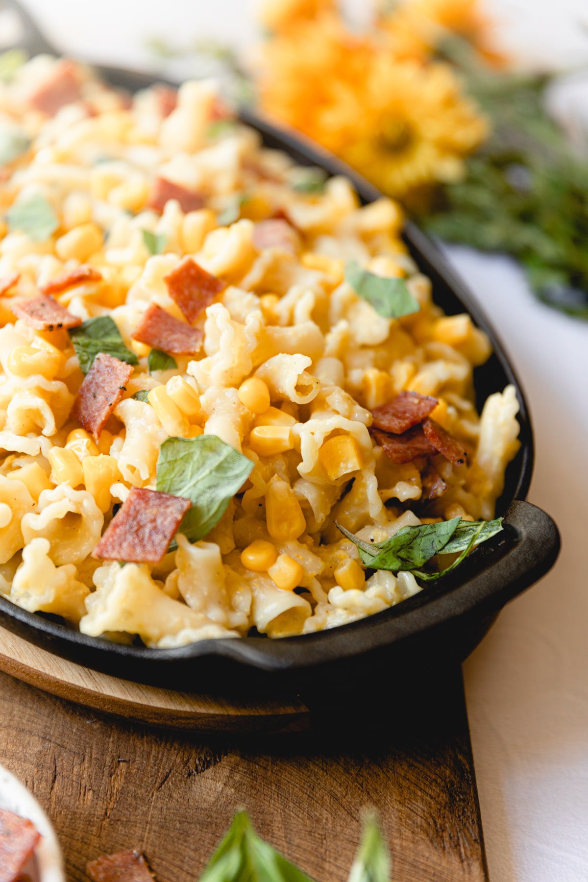 skillet full of bacon corn pasta
