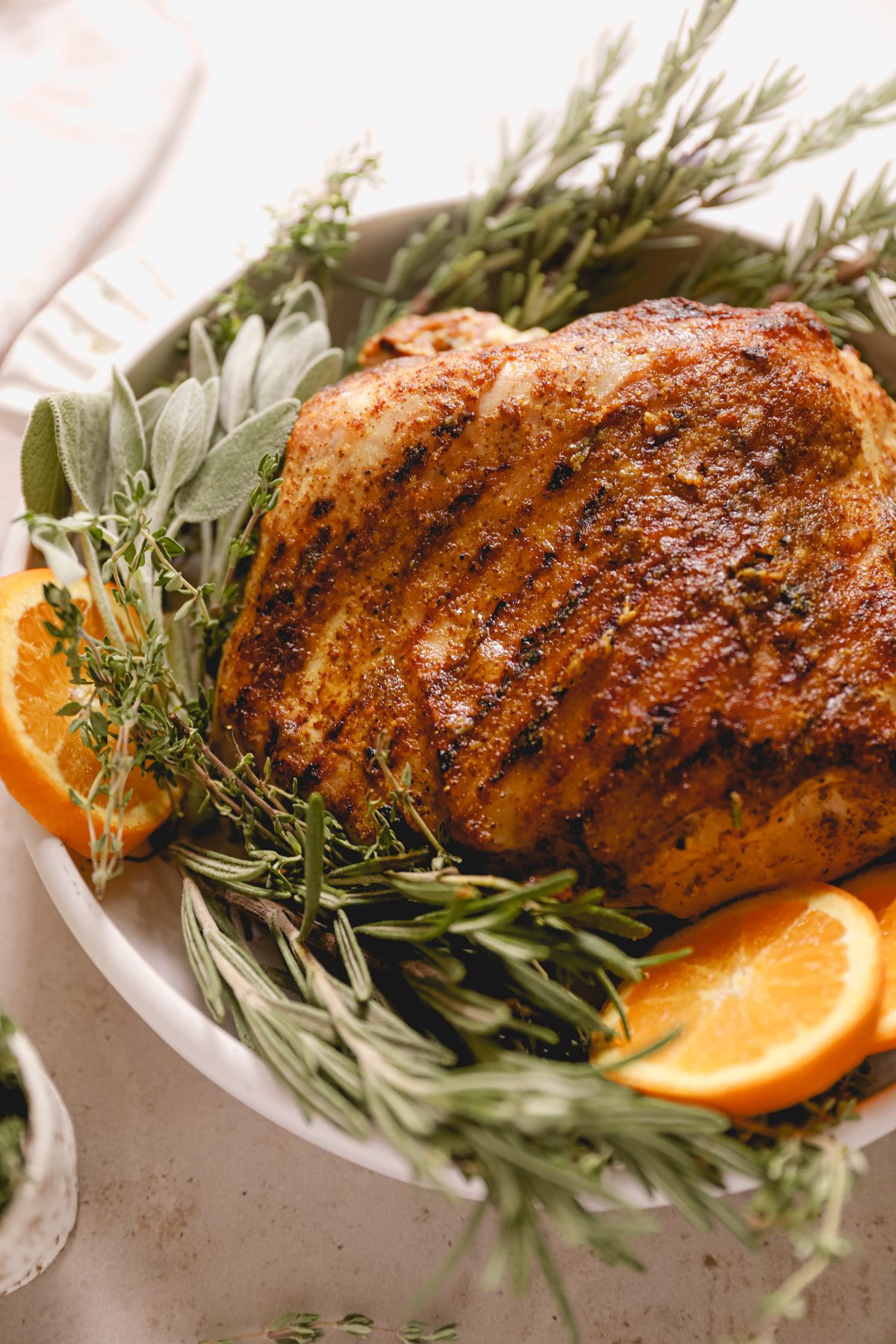 close up shot of the grilled turkey roulade garnished with herbs